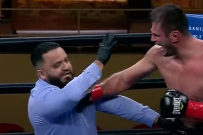 Watch heavyweight boxer PUNCH referee after being handed controversial loss which saw crowd angry with boos